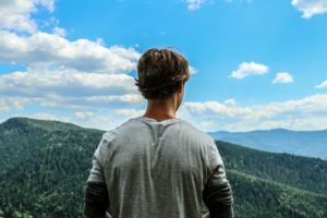 Man on mountain thinking about Substance Abuse